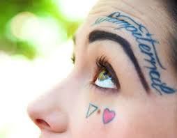 I D Never Have The Guts For A Face Tattoo But I Love The Position And Styling Of The Script Just Above Her Eyebrow M Eyebrow Tattoo Tattoos Tattoo Lettering
