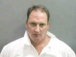 Neighbor beat dog with rake, police say