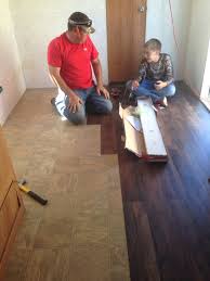 Putting Peal And Stick Floor Easy Cheap Way To Make The Floor Better Floor Remodel Updating House Living Room Redo
