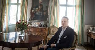 It has gold markings and he wears black shoes. German