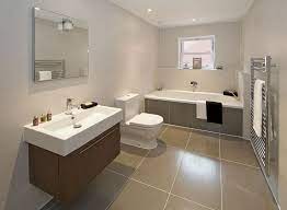 The rough brick wall and unfinished wood table of this space contrast with the smooth, geometrical look of the washbasin and mirror. Bathroom Tile Size Advice Floors Walls Showers And Tubs Top Bathroom Design Bathroom Flooring Options Simple Bathroom