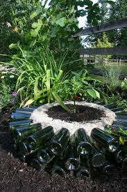 A low cob or adobe wall with glass bottles placed front to back within it can look truly stunning and be a great design feature for a garden. Wine Bottle Garden Crafts How To Use Recycled Bottles In Your Yard