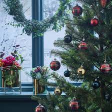 make your christmas trendy this season mix match golden accessories with deep green royal blu anthropologie christmas tree christmas deco xmas decorations