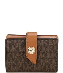 It features a center card slip with (3) card slips on each side. Michael Kors Signature Mk Charm Small Tab Card Case Wallet Dillard S