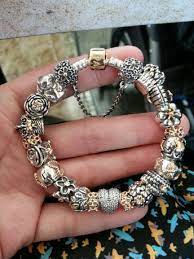 This adorable carousel charm has been beautifully crafted from sterling silver to reveal a stunning carousel design complete with horses. Silver And Gold Pandora Bracelet Yum Pandora Bracelet Pandora Bracelet Designs Pandora Jewelry