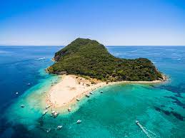Let happy moments pass under the glittering mediterranean sun, brushing off olive tree hill slopes, crystalline beaches, and tranquil coves. About Marathonisi Islet On Zakynthos Island