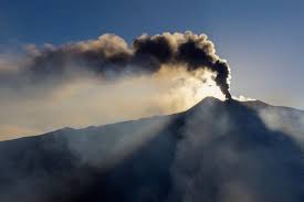 Volcanic ash plume rising from Mount Etna, Sicily, causing significant disruption to air travel.