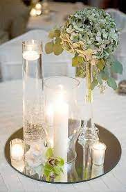 Its plain, reflective surface is broken up only by a brief bevel around its edge. Mirror Centerpiece Example Mirror Centerpiece Wedding Centerpieces Wedding Table