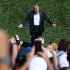 President Donald Trump walks out with Bryson DeChambeau ahead of his afternoon match at the Ryder Cup