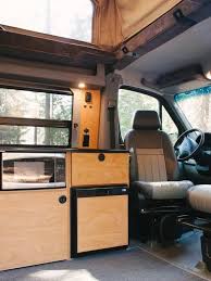Interior View Of Sportsmobile Camper Van Converison With Wood Cabinets In The Galley Kitchen Decor Inspiration Concept Home Home