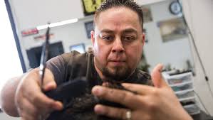PHOTOS: Haircuts and video games go together at Farmington barbershop