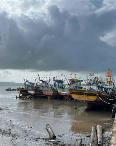 A vibrant day at Karanja fishing harbor, with purse seine boats docked and repairing to go out for new season Karanja Fishing Harbour: Where the sea meets skill! Karanja, a coastal town