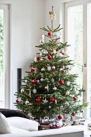 11 Tips For Decorating Your Holiday Tree Like A Pro Scandinavian Christmas Trees Cheap Christmas Trees Real Christmas Tree