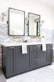 Houzz has millions of beautiful photos from the world's top designers, giving you the best design ideas for your dream remodel or simple room refresh. A Charcoal Gray Dual Bath Vanity Sits On Marble Hex Floor Tiles And Is Adorned With Brass Hardware An Grey Bathroom Vanity Grey Bathroom Cabinets Bath Vanities