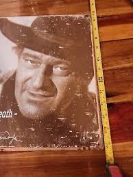 VINTAGE JOHN WAYNE "COURAGE IS BEING SCARED BUT SADDLING UP" METAL TIN  SIGN.