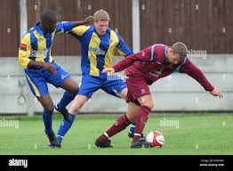 Stuart Strange (R) of Crawley Green evades Abaymoi Seymour (L) and Andy  Wands of Romford