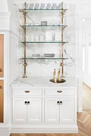 French Glass And Brass Piping Kitchen Shelves Mounted Above A White Cabinet With Gray And White Marble Kitchen Trends Diy Kitchen Renovation Kitchen Renovation