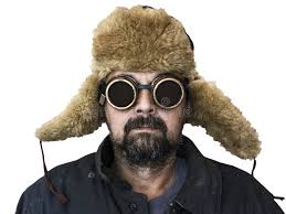 Man with Welding Glasses in a Hat with Earflaps and a Quilted Ja Stock  Photo