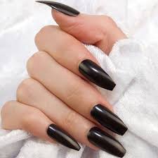 Acrylic Black Coffin Shaped Nails Jet Black Smooth And Shiny Nail Polish On The Long Coffin Nails Of A Hand With Folded Fingers Holdi Coffin Nails Long Black Acrylic Nails Coffin Shape Nails