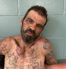 A Florida man has been charged after a woman he assaulted and held inside a  storage container escaped, police say.