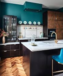 Honey oak cabinets paired with dark blue wall paint and white appliances. Trendy Kitchen Colors 2021 The 5 Best Worst Colors