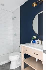 Navy Blue And White Powder Room Features A Light Oak Single Washstand Fitted With A Shelf And A Sati Bathroom Wall Colors Blue Bathroom Walls Blue Accent Walls