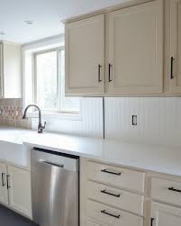 Before getting started with installing the beadboard, he first reattached the window trim with the brad nailer. How To Cover Tile Backsplash With Beadboard