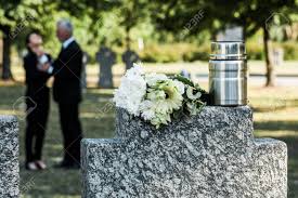 Check spelling or type a new query. Selective Focus Of Bouquet Of White Flowers And Mortuary Urn On Tombstone Near Man And Woman Stock Photo Picture And Royalty Free Image Image 130214433