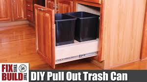 pull out trash can in a kitchen cabinet