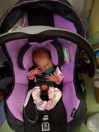 A Tiny Baby Girl In A Purple And Black Car Seat Baby Shower Decorations For Boys Car Seats Boy Baby Shower Food