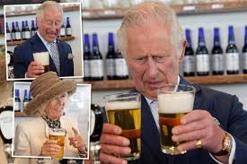 Prince Charles and Camilla pull pints ...