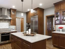 Corner double oven with 36″ electric cooktop is a cooks dream! Warm Cherry Cabinets Bradford And Kent Custom Remodeling