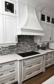 Gorgeous Kitchen With Crisp White Cabinetry Marble Countertops And Black Grey Tile Backsplash Eclectic Kitchen White Backsplash Contemporary Kitchen