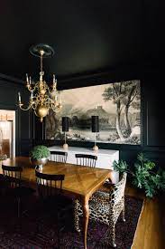 Paint is a relatively inexpensive way to completely transform a room, and dark rooms are no exception. Comfort Zone Gwen Hefner Gold Dining Room Dark Dining Room Black And White Dining Room