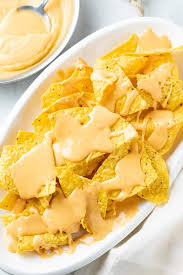 Nachos is a typical mexican dish and can be accompanied by numerous sauces, although one of the most common recipes is to make cheesy nachos with that typical melted cheese sauce we all enjoy with that characteristic orange color. Nacho Cheese Sauce The Cozy Cook