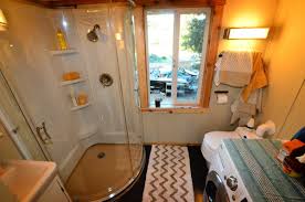 Small living room area next to stairs inside tiny home. Five Cool Tiny House Bathrooms Tiny Home Builders