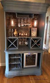 To recreate the look, snag a distressed freestanding buffet ($172) or sideboard and pair it with wrought iron and white ceramic accents. Etsy Cheap Basement Ideas Unfinished Basement Lakes Marlboronj Bar Ideas Coffee Bar Home Armoire Bar Rustic Bar