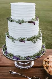 Closeup of three tier wedding cake with flowers and orange ribbons. Lavender Wedding Cakes Lemon Lavender Wedding Cake