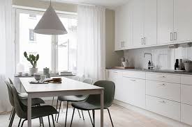 modern white kitchen with big dining table