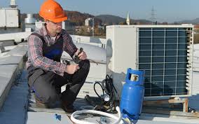 An air conditioning engineer is finishing the installation of several units on a rooftop. Florida Hvac Training Fast Programs For A Reliable Trade