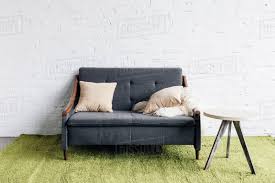 Download Small Couch In Modern Living Room With White Brick Wall Mockup Concept Stock Photo Dissolve