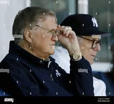 New York Yankees principal owner George Steinbrenner, foreground, changes  his glasses during the Yankees' 9-8 win over the Detroit Tigers in their  spring baseball game, Sunday, March 26, 2006, at Legends Field