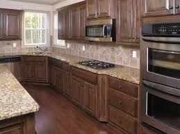 Light tones kitchen room with cherry wood cabinets, marble counter tops and modern appliances. Maple Vs Oak Cherry And Birch Cabinets