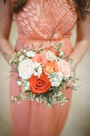In place of a wedding bouquet, a minimalist gold wedding wreath was draped with foliage, peach carnations and cream roses as a whimsically modern bouquet alternative. Coral Palette Bridesmaids Bouquets For Masonic Temple Wedding