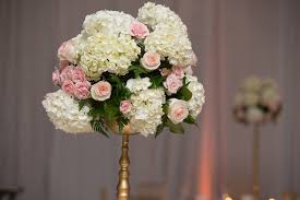 A lot goes into planning your reception décor—especially the tables. Tall Pink Rose And White Ivory Hydragena Wedding Reception Table Centerpieces On Gold Flower Stand Tampa Wedding Floral Designer Northside Florist Beautiful Tampa Weddings