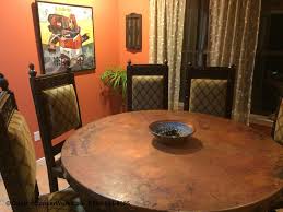 A charming 17th century style dining table, reconstructed from reclaimed teak wood that stands on smooth polished lyra legs conjoined with iron stretchers. Copper Top Table Hacienda Style With Decorative Rivets
