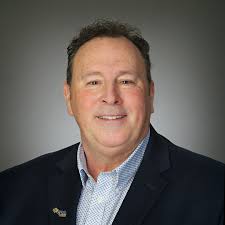 Headshot with a grey background matches today's cloudy day