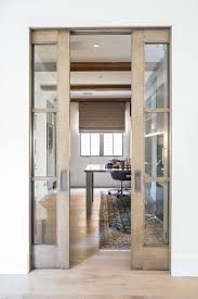 Wood And Glass Pocket Doors Open To A Work Space Furnished With A Gray T Shaped Desk Placed Above A Glass Office Doors Glass Pocket Doors French Doors Interior