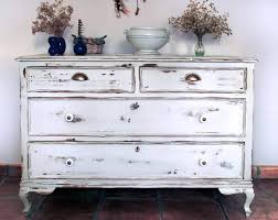 Distressed antique white paint with 5 drawers and brass hardware. Age Your Wooden Furniture With A Distressed Paint Effect