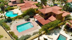 Upstair is the ample master bedroom and bathroom with a balcony to enjoy the stunning ocean view. Mesa Vista 11 Tierra Del Sol Aruba Beautiful House Located In The Gated Community Of Tierra Del Sol Resort Golf 3 Bedro House Styles Real Estate Mansions